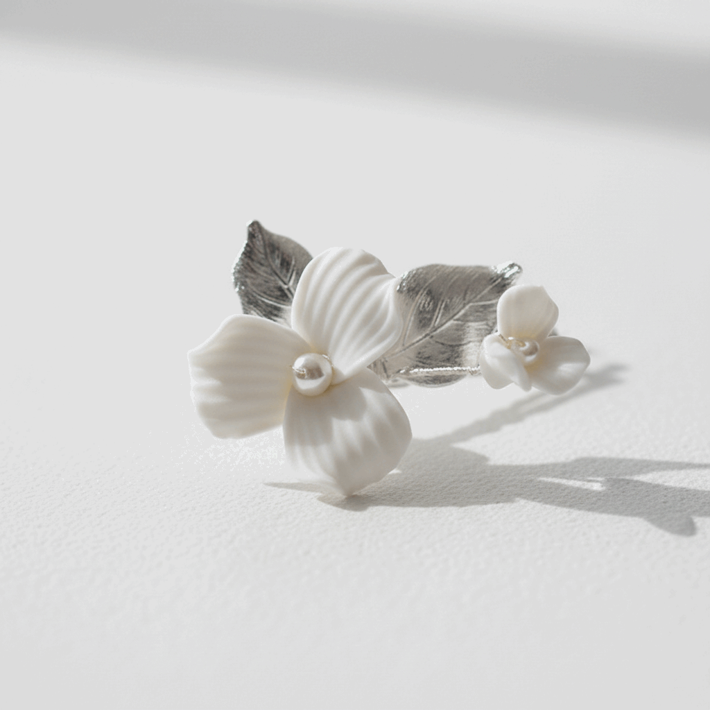 Close-up of silver-plated porcelain blossom and leaf hair pin for weddings