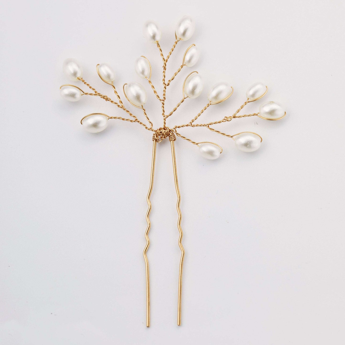 Delicate gold pearl bridal hair pin with a branch design