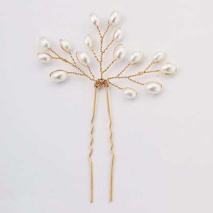 Delicate gold pearl bridal hair pin with a branch design