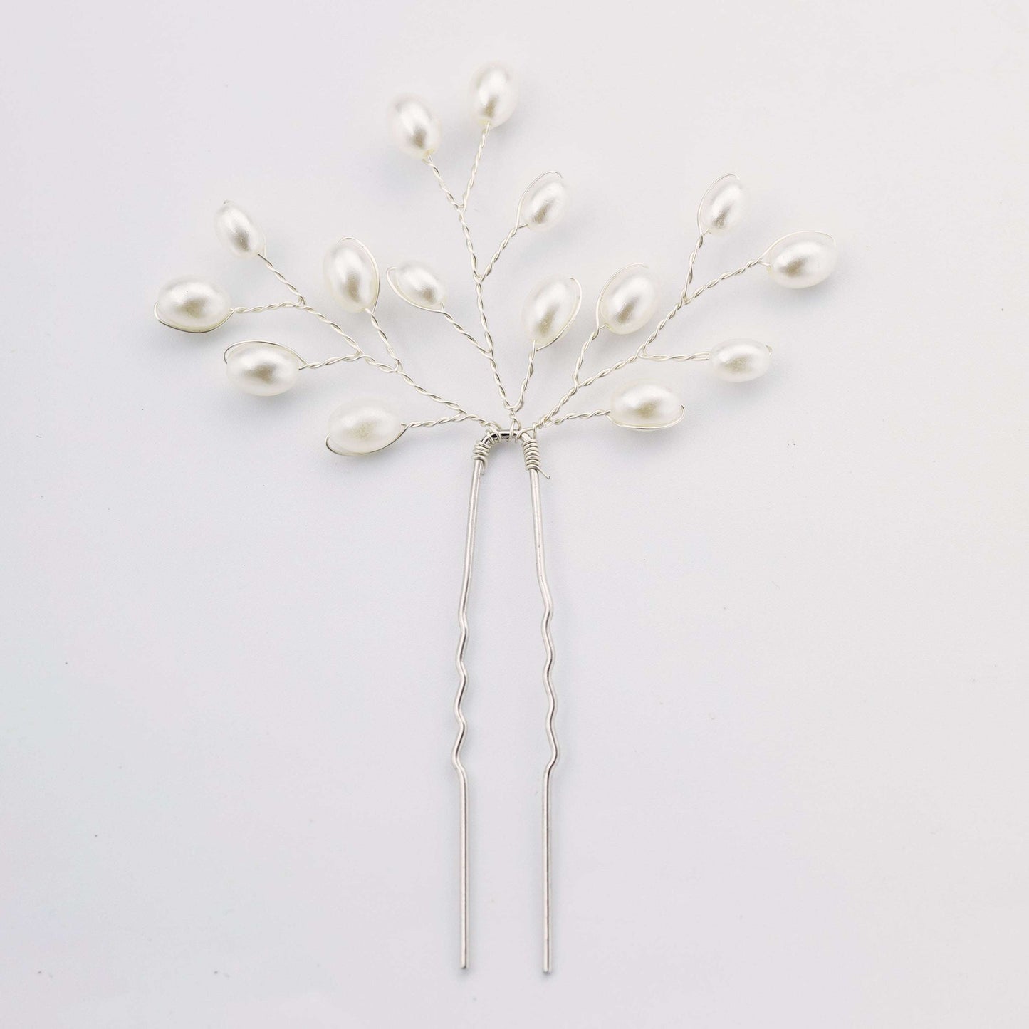 Delicate silver pearl bridal hair pin with a branch design