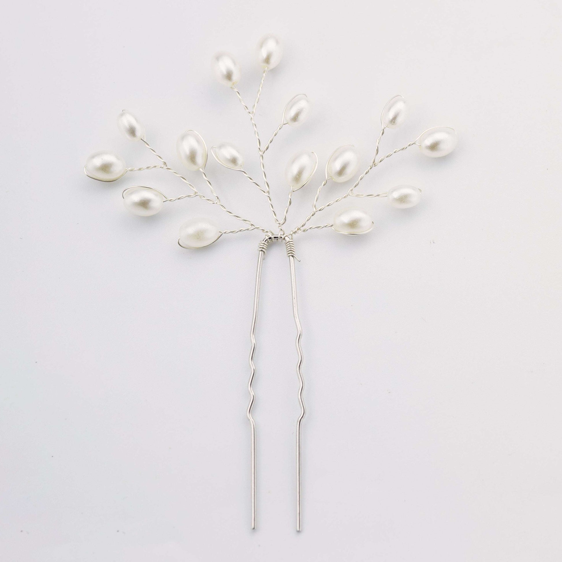 Delicate silver pearl bridal hair pin with a branch design