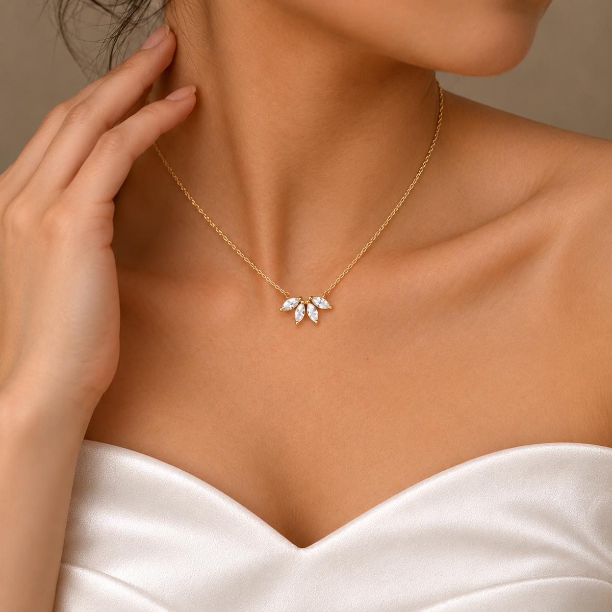 Side view of a floral pendant necklace with the model touching her neck