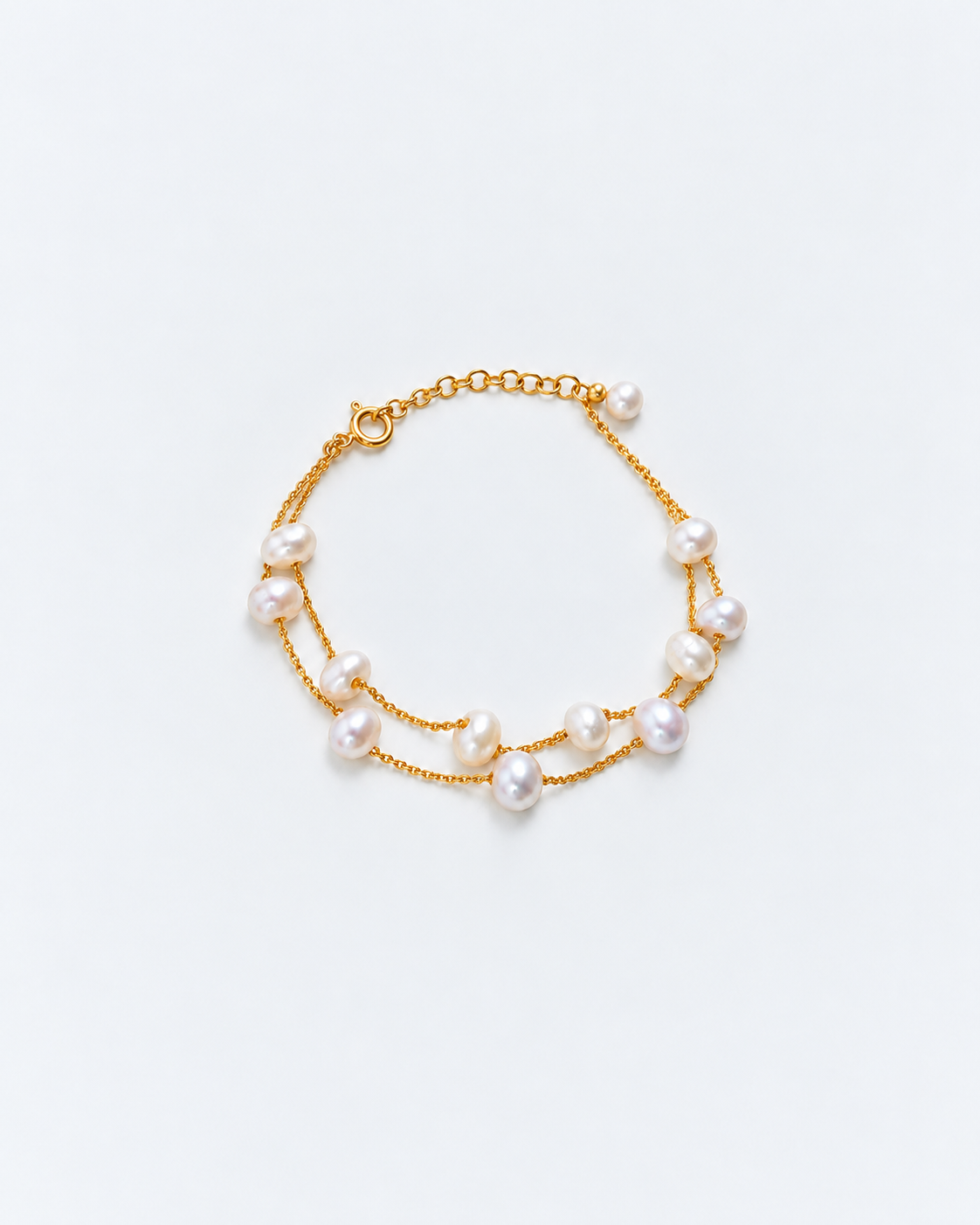 Freshwater pearl bracelet with two gold chains and a pearl-tipped extension chain