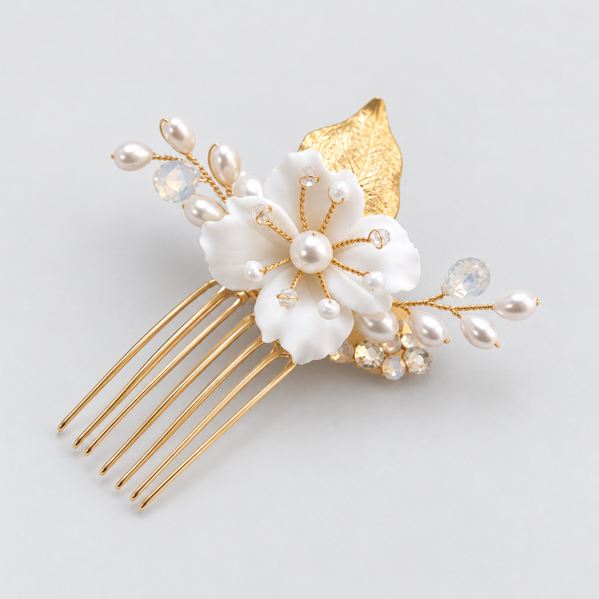 Angled product view of the white flower bridal hair comb with crystal accents and gold-tone comb teeth.