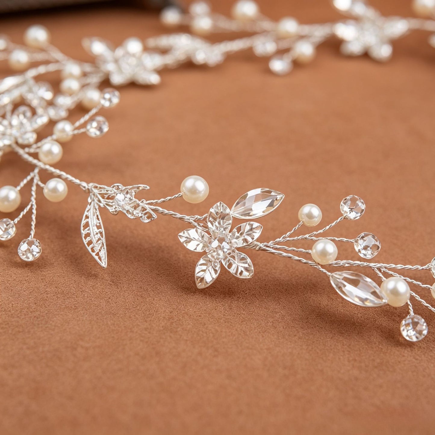 Close-up of pearl and crystal detailing on silver bridal hair vine headpiece