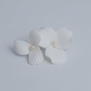 ANNA white porcelain flower and pearl bridal drop earrings laid flat