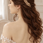 Rear three-quarter view of a bride wearing a gold leaf hair comb in long brown half-up curls