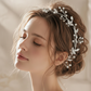Bride wearing silver pearl crystal hair vine woven through elegant wedding updo hairstyle