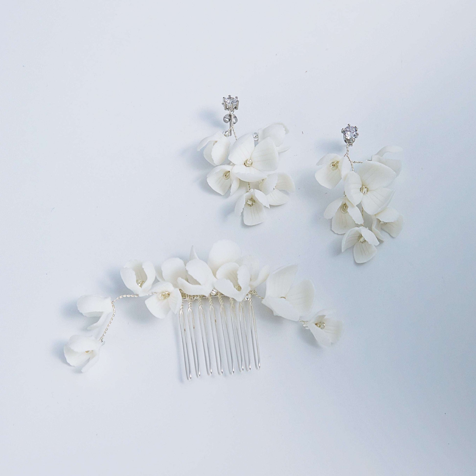 OLIVIA ivory clay blossom earrings and matching hair comb set on a white background