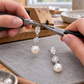 Illustrative workshop scene showing assembly of crystal and pearl earrings with jewellery pliers