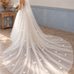 Full-length rear view of a floral cathedral wedding veil with its train spread across the floor