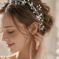 Bride wearing silver pearl crystal hair vine woven through elegant wedding updo hairstyle