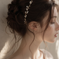 Bride wearing delicate pearl and gold wire wedding crown in side profile, showcasing lightweight adjustable bridal headpiece