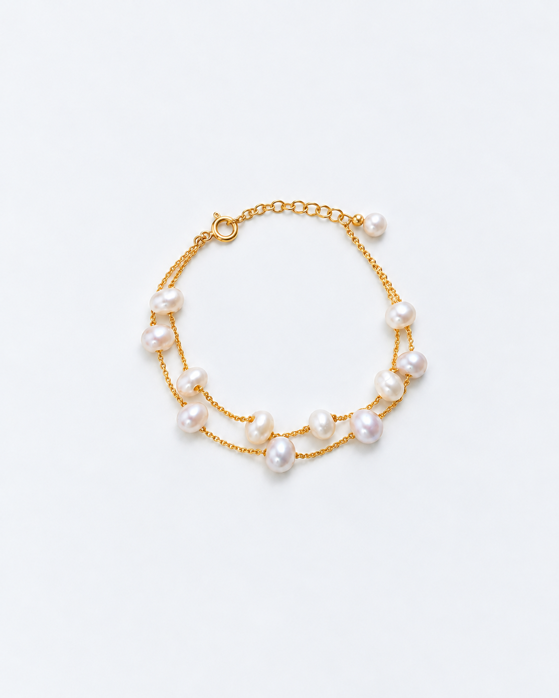 Overhead view of a delicate double-strand gold pearl bracelet