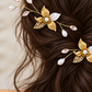 Close-up of gold bridal combs showing pearl centres, engraved leaves and CZ-set openwork leaves