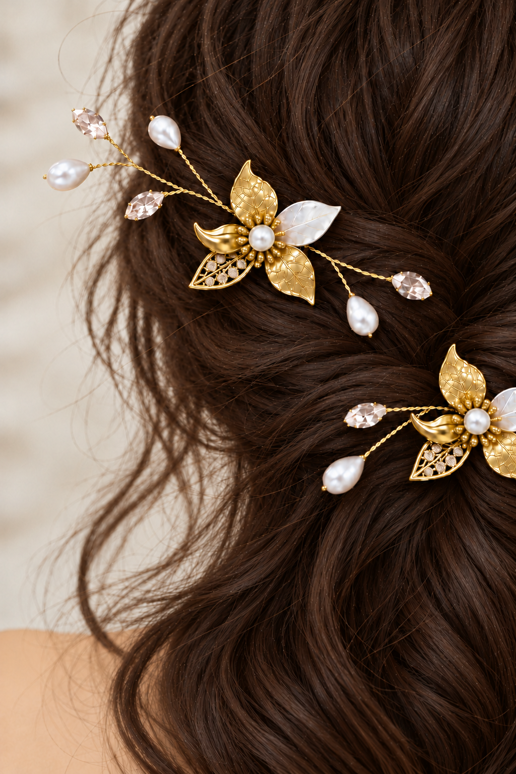 Close-up of gold bridal combs showing pearl centres, engraved leaves and CZ-set openwork leaves