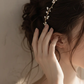 Close-up detail of freshwater pearls and twisted gold-plated wire on handmade bridal crown, showing intricate hand-wrapped craftsmanship