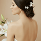 Model wearing the ISLA porcelain flower hairpins in a low bun