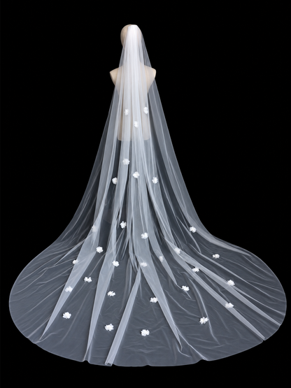 Full view of a white floral cathedral wedding veil displayed on a mannequin against a black background