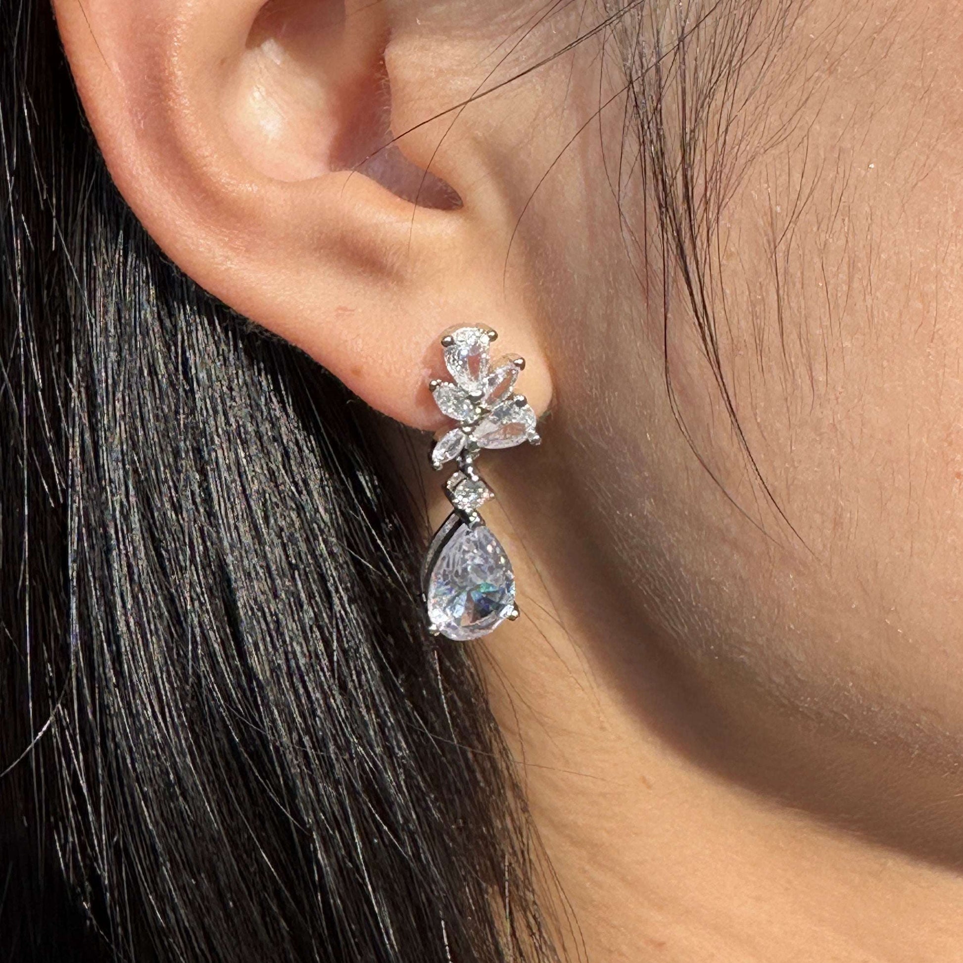 Model wearing EVIE silver crystal drop bridal earrings