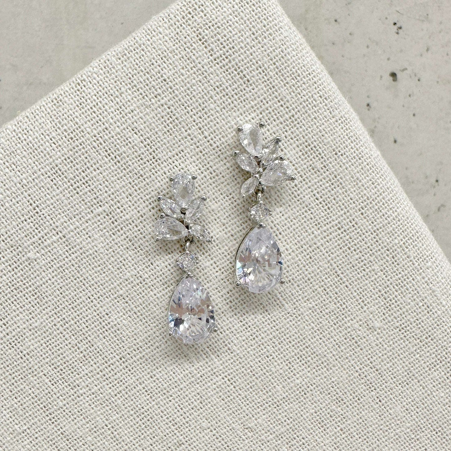 EVIE floral-inspired silver wedding earrings on a white background