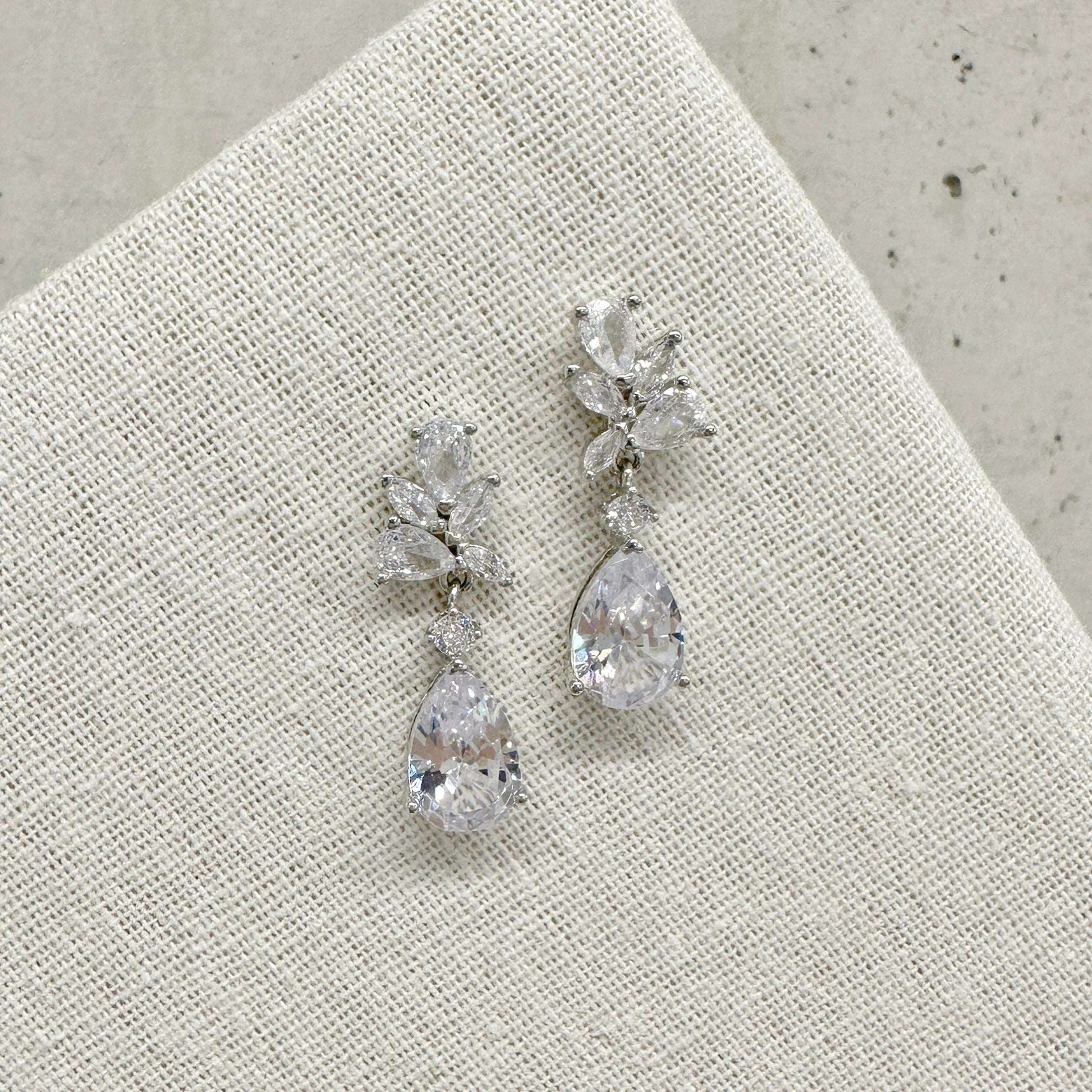 EVIE floral-inspired silver wedding earrings on a white background