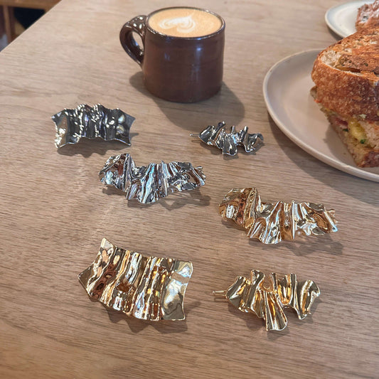 Collection of handmade gold and silver metal hair clips for brides