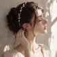 Handmade pearl and gold wire wedding crown displayed on dark emerald velvet, featuring luminous freshwater pearls hand-wrapped in delicate gold-plated wire