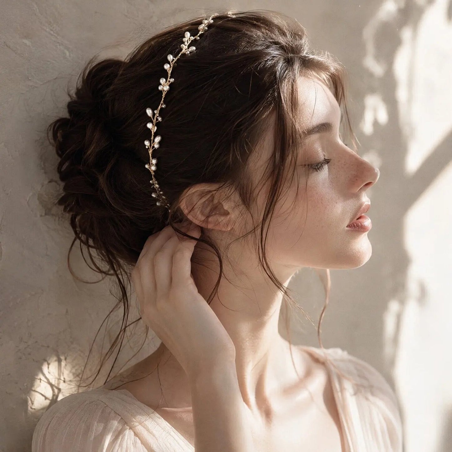 Handmade pearl and gold wire wedding crown displayed on dark emerald velvet, featuring luminous freshwater pearls hand-wrapped in delicate gold-plated wire