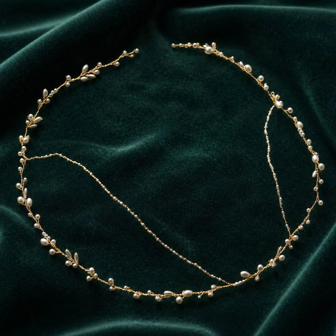 Full flat lay view of handmade pearl and gold wire wedding crown, showing adjustable wire construction and ivory pearl placement
