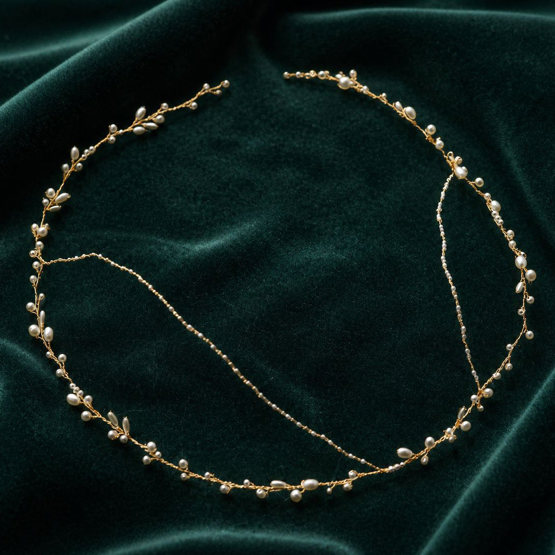 Full flat lay view of handmade pearl and gold wire wedding crown, showing adjustable wire construction and ivory pearl placement