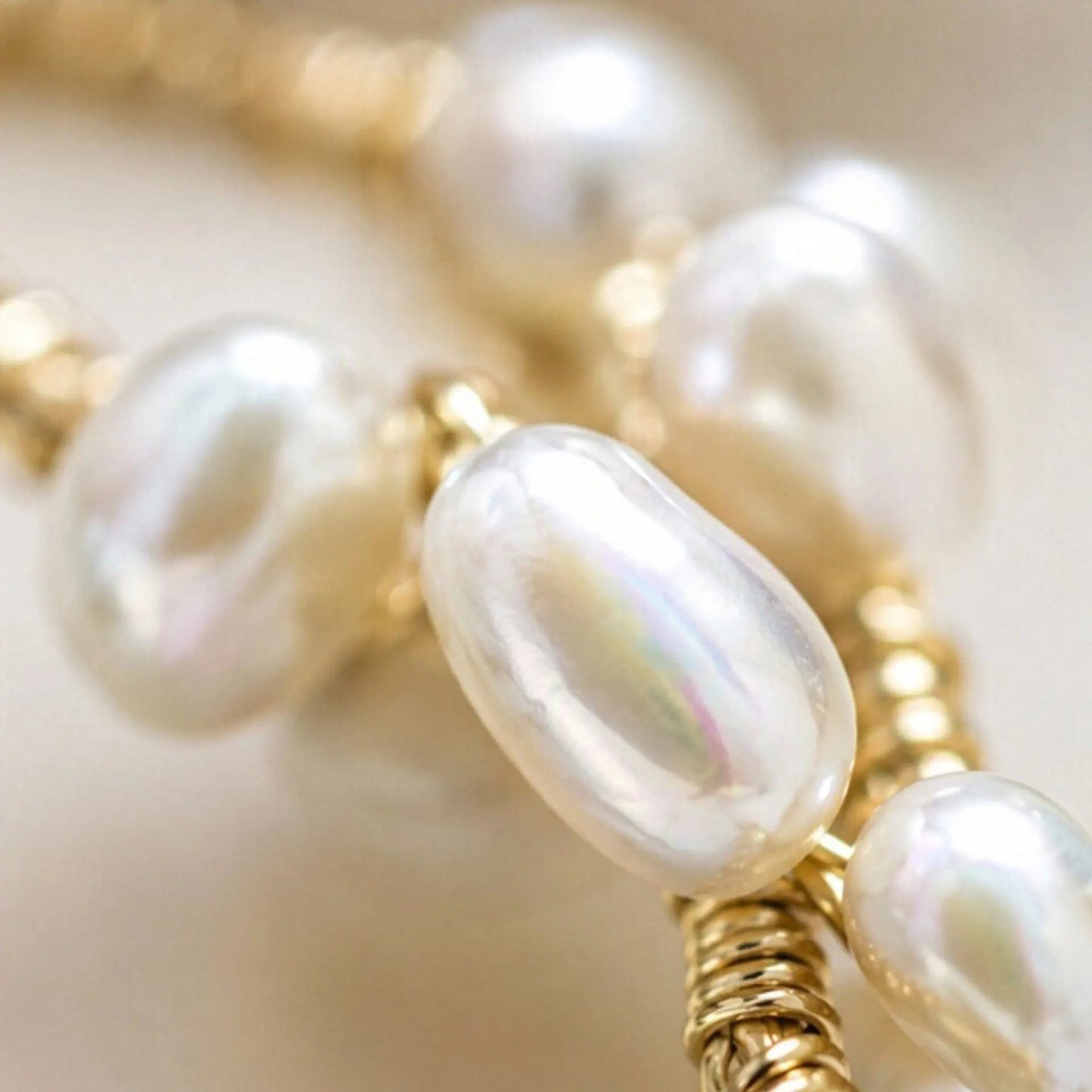 Close-up detail of freshwater pearls and twisted gold-plated wire on handmade bridal crown, showing intricate hand-wrapped craftsmanship
