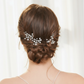 Model with a romantic braided updo wearing pearl hair accessories