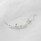 Adjustable floral bracelet with white ceramic blooms and leaf accents, gold chain bridal wrist jewellery