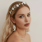 Bride wearing white porcelain flower headband with gold leaves wedding day