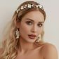 Bride wearing white porcelain flower headband with gold leaves wedding day