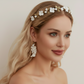 Bride wearing white porcelain flower headband with gold leaves wedding day