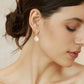 Bride wearing pearl drop earrings - delicate wedding jewelry on model
