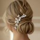 Model wearing the LILLIAN gold porcelain flower hairpin in a low bun