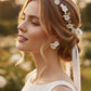 Bride wearing gold floral bridal jewelry set with pearl hair vine and white flower earrings for outdoor garden wedding