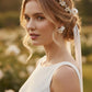 Bride wearing floral bridal jewelry set with flower earrings, pearl hair vine and matching bracelet for garden wedding