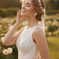 Bride wearing floral bridal jewelry set with flower earrings, pearl hair vine and matching bracelet for garden wedding