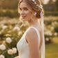 Bride wearing floral bridal jewelry set with flower earrings, pearl hair vine and matching bracelet for garden wedding
