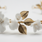 Gold leaf porcelain flower detail on white bridal headband
