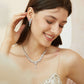 Model wearing the NORA floral crystal drop earrings with a matching necklace