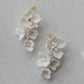 White floral earrings on a light gray background