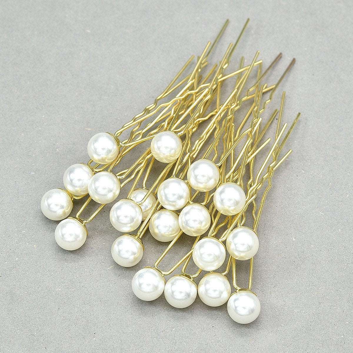 Detailed view of the handmade Gold pin and lustrous pearl