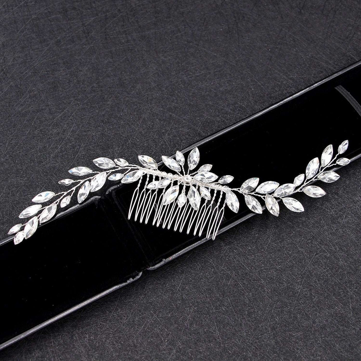 Sparkly rhinestone bridal hair comb on a black background