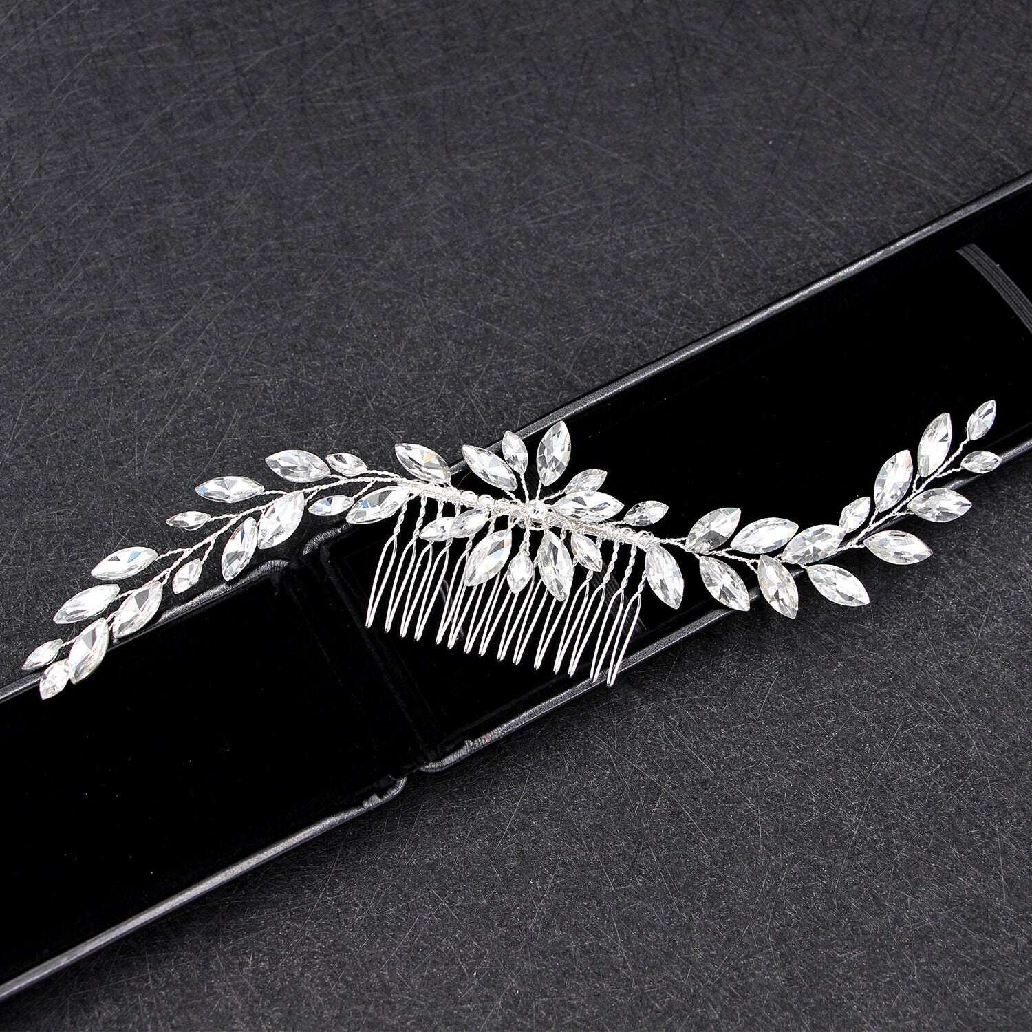 Sparkly rhinestone bridal hair comb on a black background