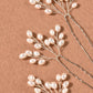 Close-up of the handmade pearl and wire detail on the hair pin